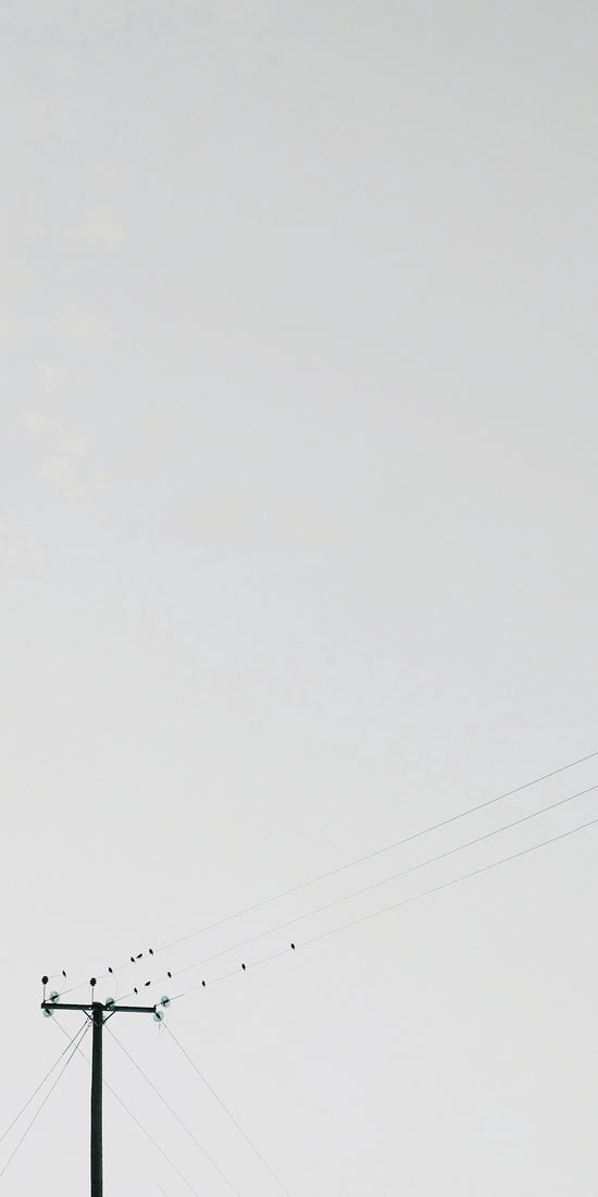 transmission post under white clouds