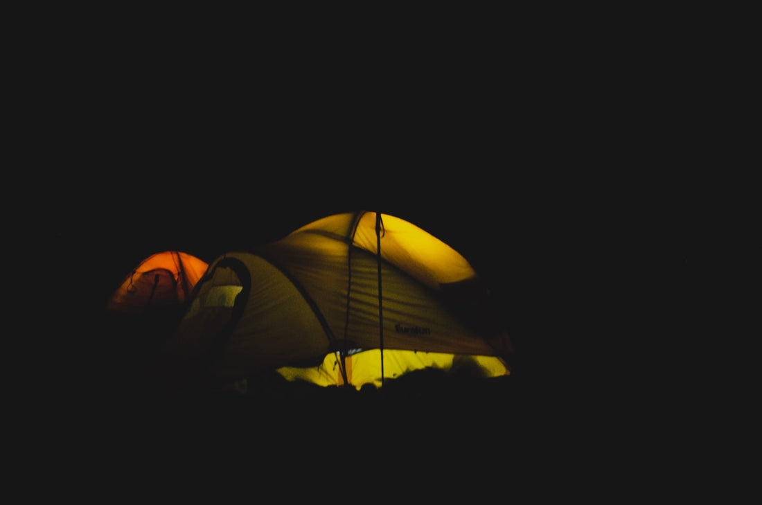 yellow and red dome tent with light at nighttime
