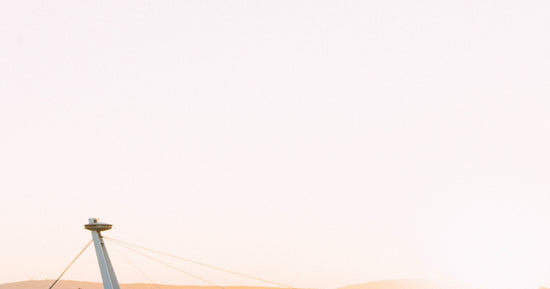 a man flying a kite on top of a sandy beach
