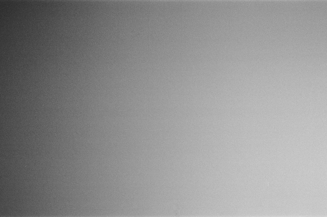 a black and white photo of a person holding a cell phone