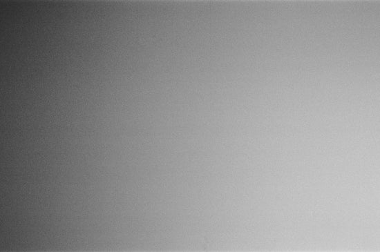 a black and white photo of a person holding a cell phone