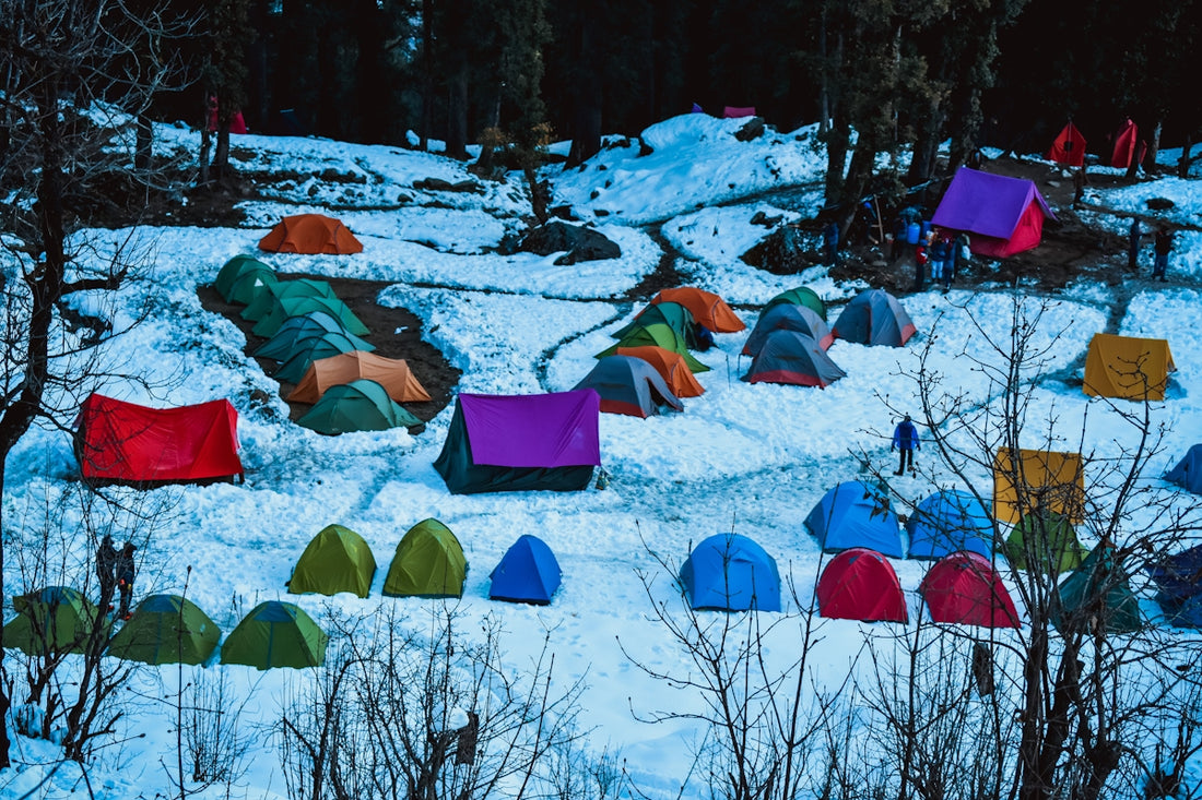blue and orange tent on snow covered ground during daytime