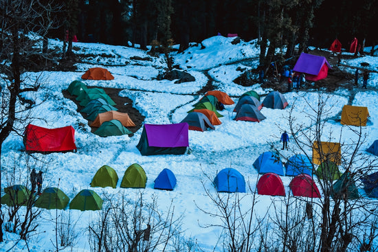 blue and orange tent on snow covered ground during daytime