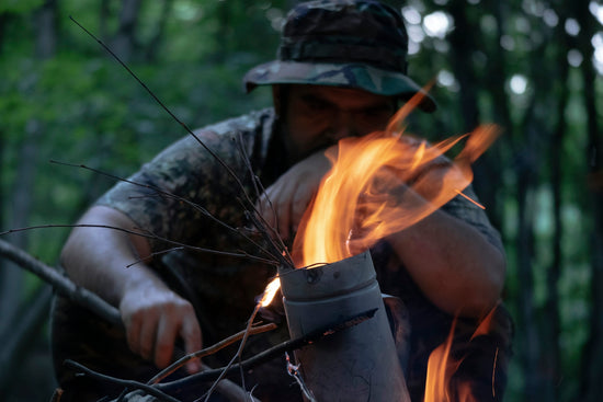 man in black and white camouflage jacket holding fire