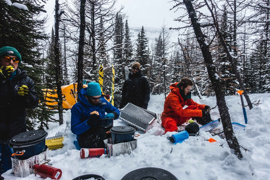 people sitting on snow covered ground during daytime