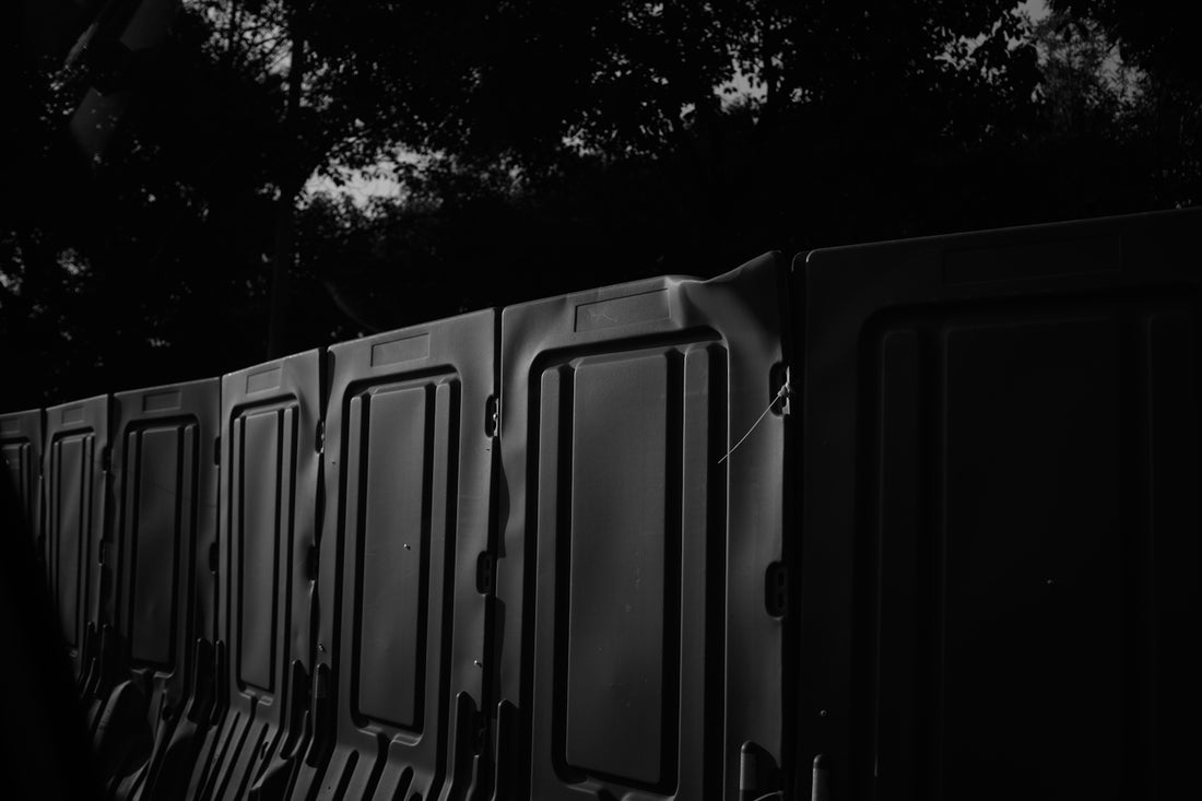 black metal gate near green trees during daytime