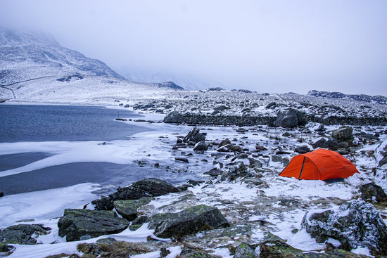 red umbrella on snow covered ground during daytime