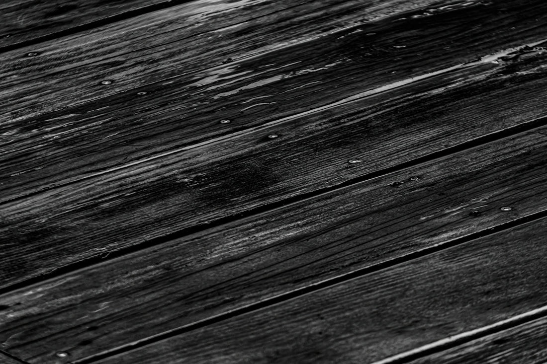 a black and white photo of a wooden floor