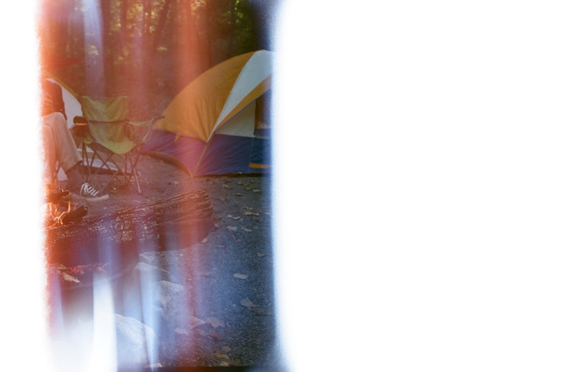 a blurry image of a tent and a campfire