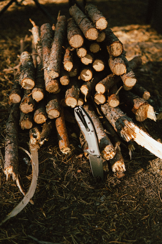 a knife on a pile of cut up wood