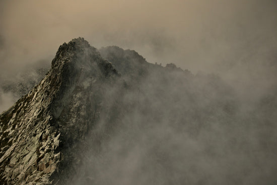 a mountain with clouds around it