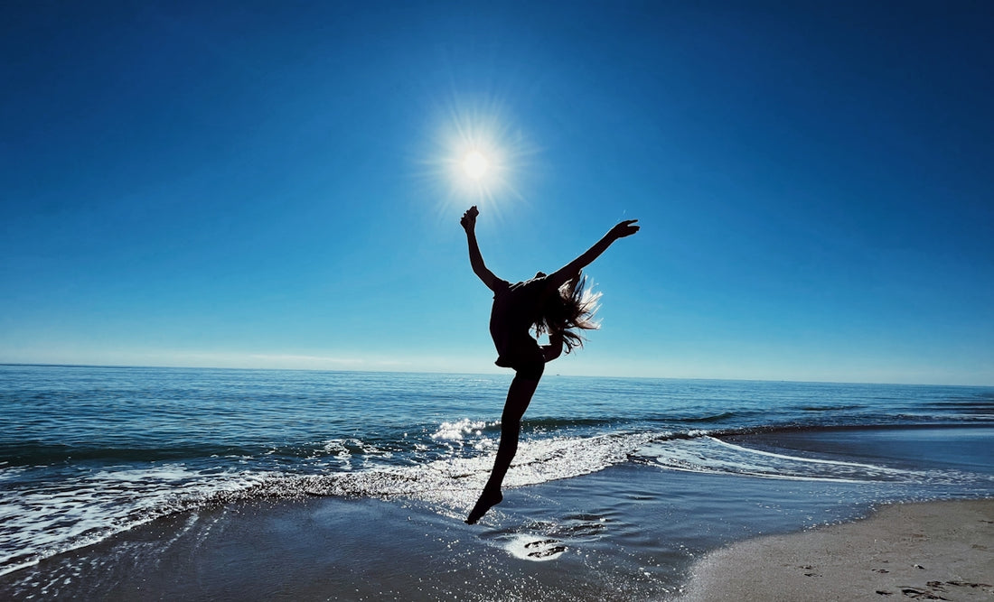 a person jumping on a beach