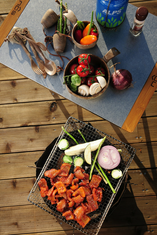 a table topped with bowls of vegetables and meat