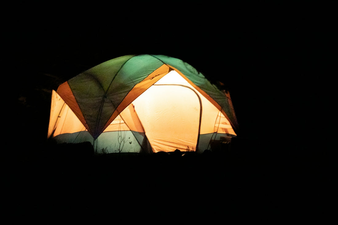 a group of tents lit up in the dark