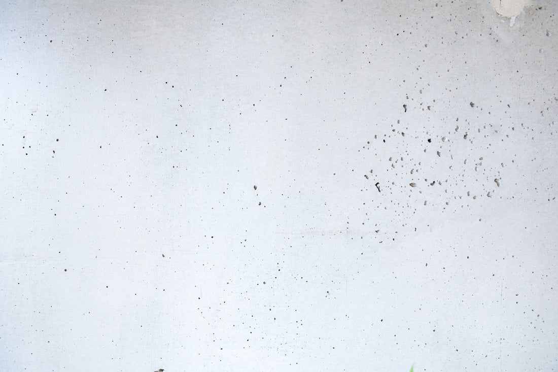 a white wall with a bunch of dirt on it