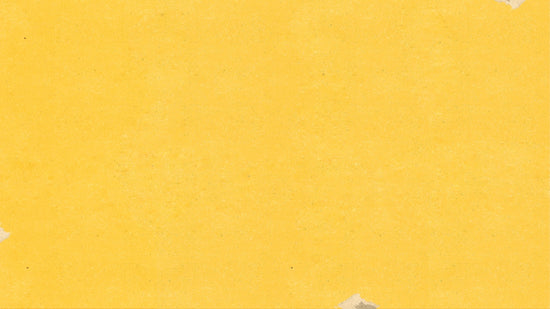 a piece of yellow paper with torn edges