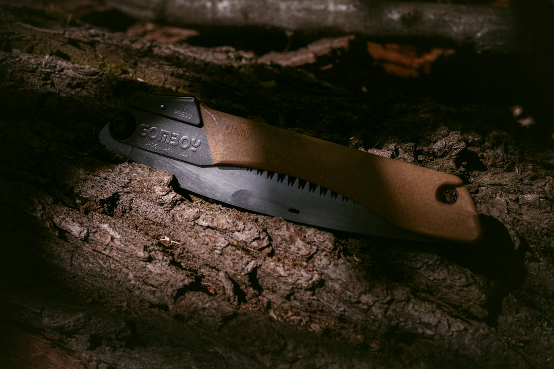 a knife is laying on a piece of wood