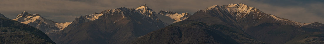 a group of mountains with clouds in the sky
