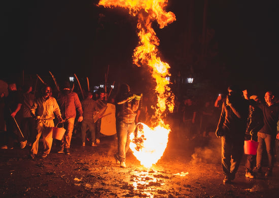A group of people standing around a fire
