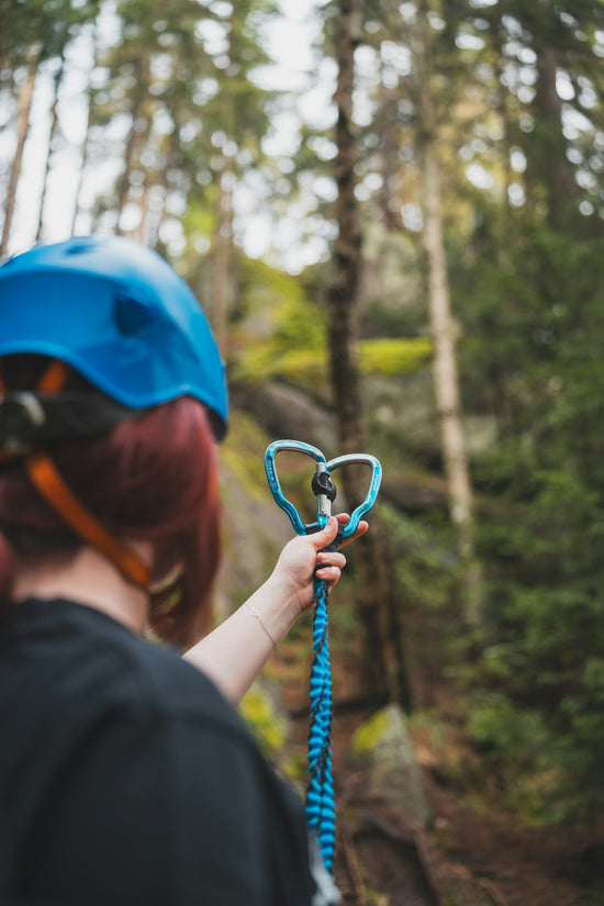A woman wearing a helmet and holding a pair of scissors