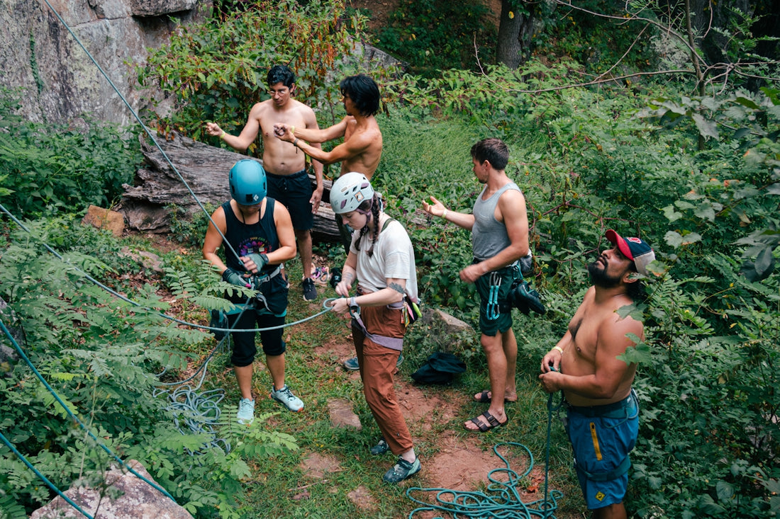 A group of men standing on top of a lush green hillside