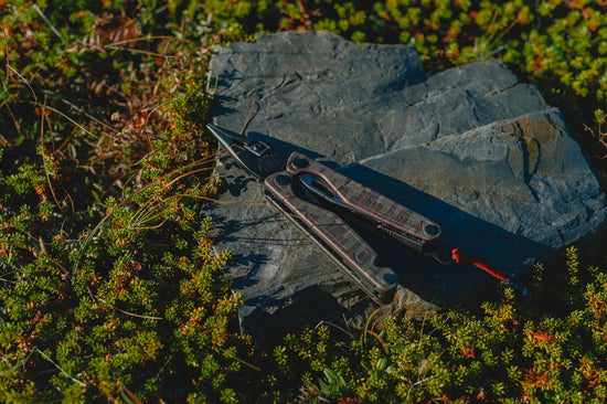 A pair of scissors sitting on top of a rock