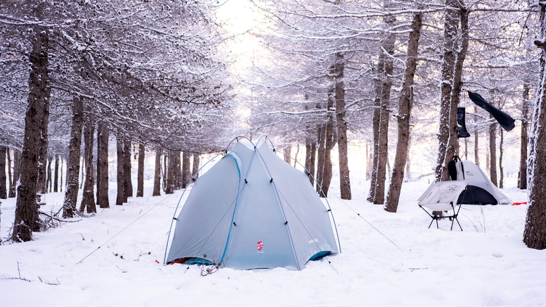Camping in a snowy winter forest.