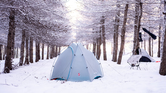 Camping in a snowy winter forest.