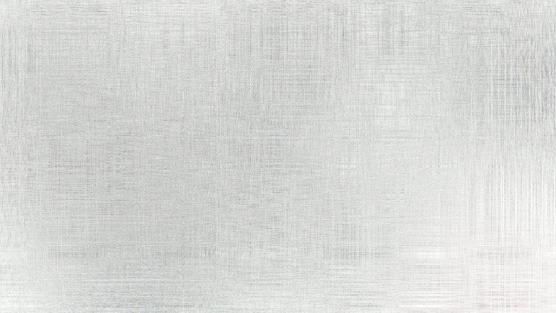 A brushed metal surface with subtle texture.