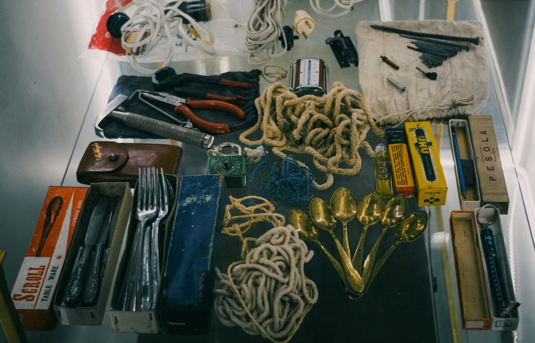 Collection of vintage tools and cutlery laid out utensils