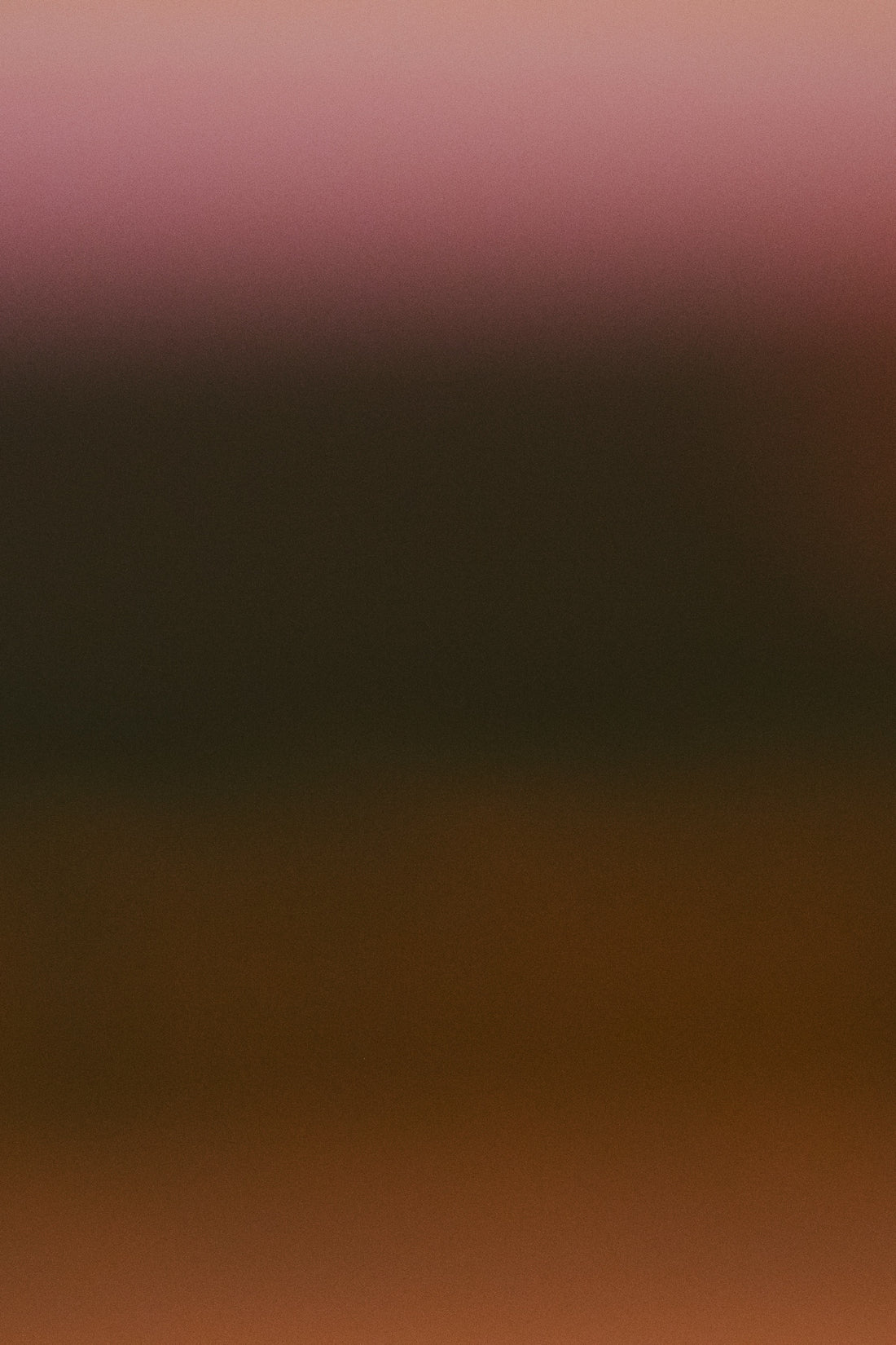 A soft gradient of brown and pink hues.