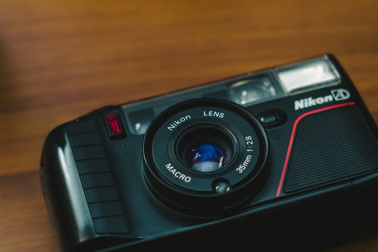A black nikon camera with a macro lens