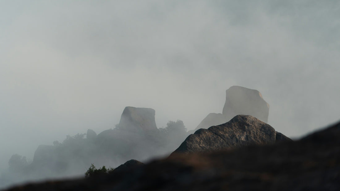 Misty mountain peaks shrouded in dense fog.