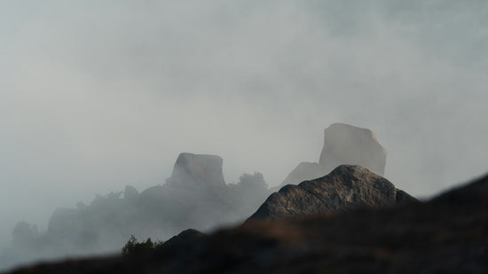 Misty mountain peaks shrouded in dense fog.